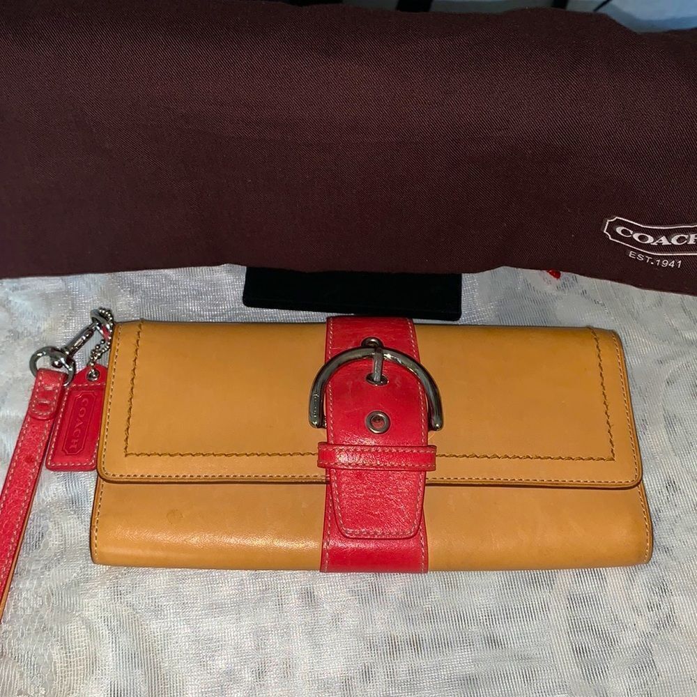 Coach leather medium size pink and tan wristlet with duster bag